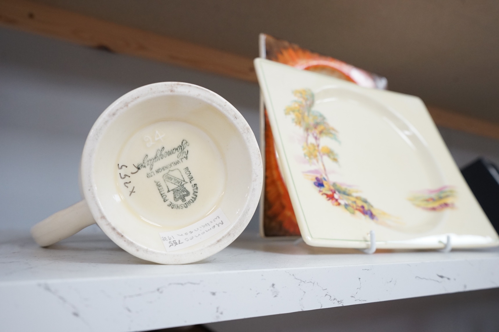 Three Clarice Cliff Bizarre ‘Biarritz’ dishes and a Wilkinson floral jug, largest 23cm wide